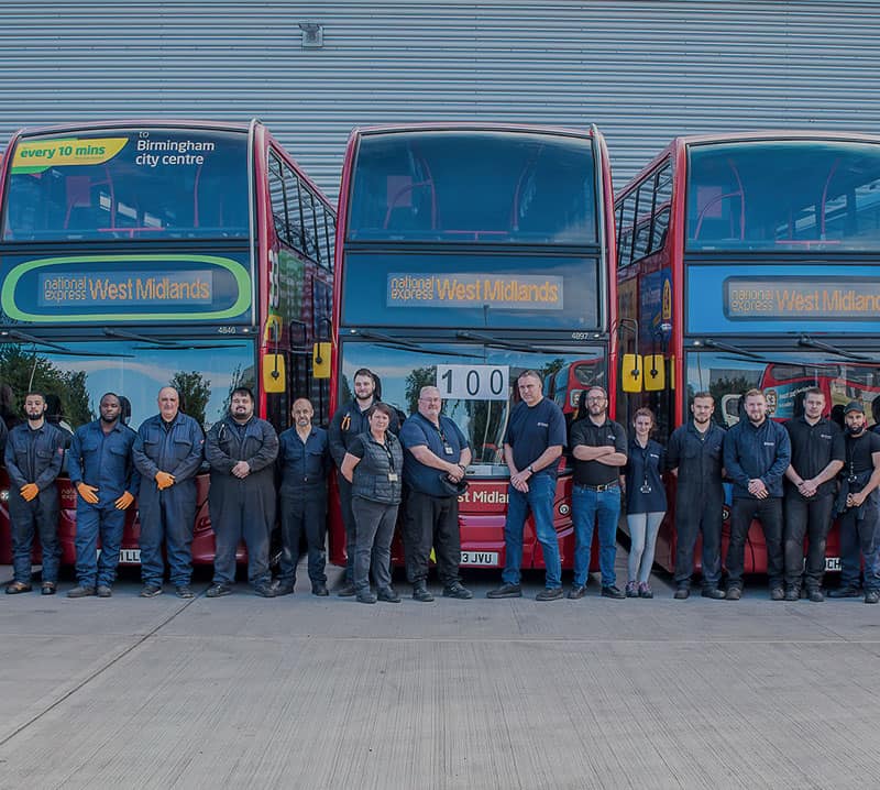 GTS employees stand in front of buses at Grayson Thermal System's Servicing Centre after converting mutliple vehicles to make them COVID-safe